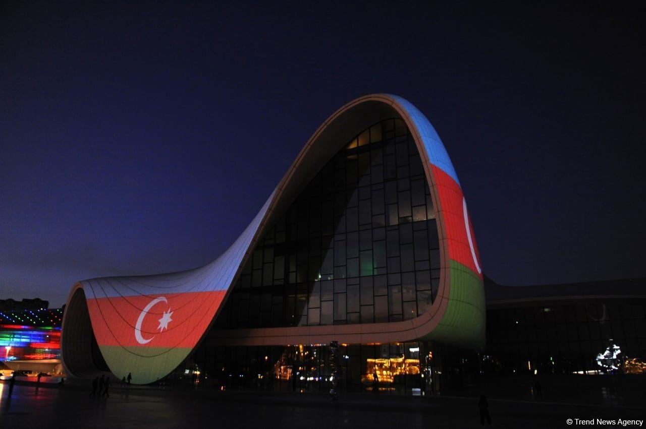 Heydar Aliyev Center in Baku illuminated with colors of National Flag of Azerbaijan