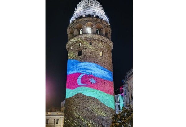Galata Tower in Istanbul illuminated with colors of Azerbaijani flag